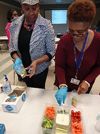 City of Jackson senior services staff Christi Johnson and Sharon Dallis take part in the snack preparation activity at the Flowood workshop
